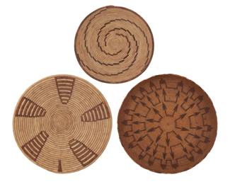 2037 Three basketry items 20th century Comprising two coiled African bowls and a possibly Indonesian/Polynesian twined tray with arrow motifs 3 pieces Widest: 3.75" H x 20" Dia.; Smallest: 4" H x 14.5" Dia. Estimate: $100 - $200