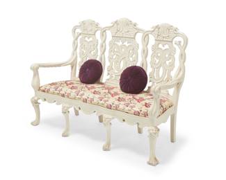 2028 A Dutch Rococo style white painted settee 20th century The carved wood frame with openwork seatback featuring bird-form figural and scrolled motifs, above a later fabric upholstered seat cushion, raised on eight, the front four displaying upper masks in relief and paw feet, together with two associated tufted round pillows 46.25" H x 68" W x 27" D Estimate: $100 - $200