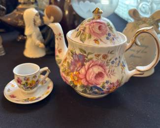 Teapot and miniature cup and saucer
