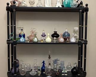 Vintage Perfume Bottle Collection on Black Shelving