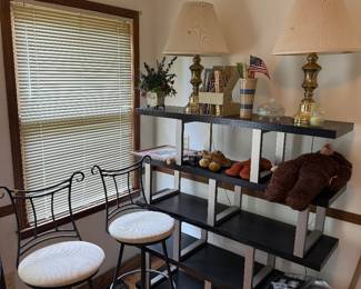 black and silver meta bookcase, barstools, brass lamps