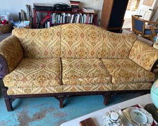 vintage Chippendale-style camelback sofa features intricate carved mahogany