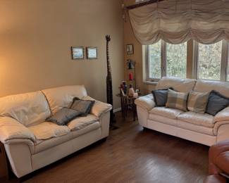 Two off white leather love seats