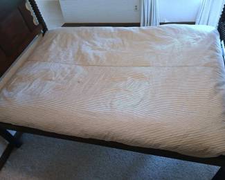 The antique rope bed's feather mattress
