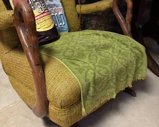 antique recliner with carved swan head arms. Needs reupolstering.