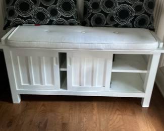 White Storage Bench with Sliding Doors and Decorative Pillows