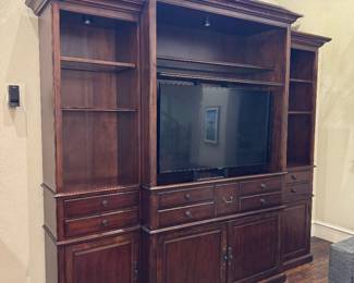 Weir’s Traditional cherry entertainment center with motorized TV lift and built-in accent lighting. Very heavy. Remote included.