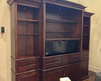 Weir’s Traditional cherry entertainment center with motorized TV lift and built-in accent lighting. Very heavy. Remote included.