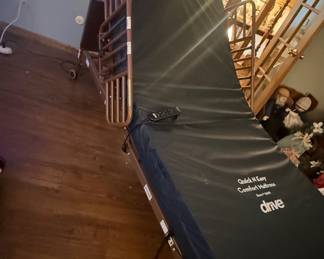 Adjustable electric hospital bed with railings and mattress