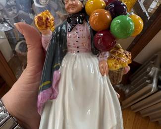 Royal Doulton “Biddy Pennyfarthing” woman, and man pair