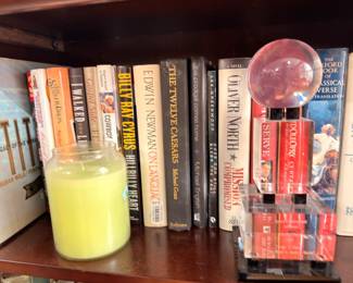 Books, crystal ball on stand, and candle
