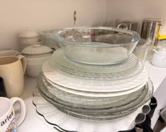 Glass serving platters, Pyrex bowl, and everyday dishes