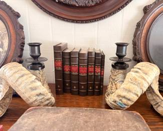 Ram horn bookends, antique books, oval frames, candlesticks
