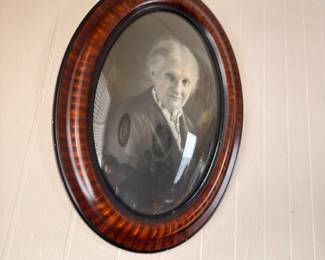 Antique oval tiger wood frame with bubble glass portrait
