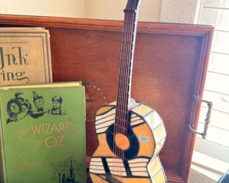 Acoustic guitar on stand, antique Wizard of Oz book