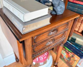 Antique carved walnut side table with drawer, rabbit bookends