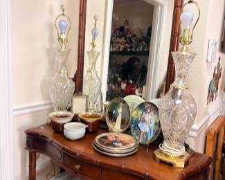 Carved console table with mirror, crystal lamps, collector plates