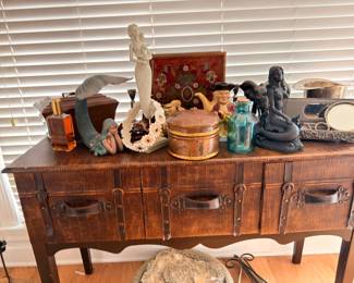 Leather wrapped campaign style console table, mermaid figurines