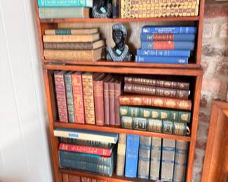Bookcase of antique leather bound books and busts