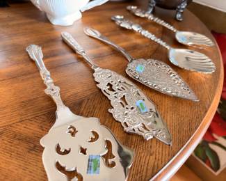 Ornate silver plate serving pieces, cake servers and spoons