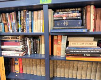 Bookshelf of vintage hardcover novels and art books