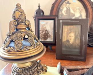 Antique photographs and ornate gilt finial decor