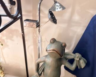 Whimsical frog garden statue in shower