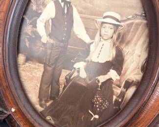 Antique carved oval frame with early portrait photo