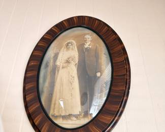 Antique wedding portrait in oval tiger wood bubble glass frame