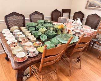 Oak dining table with cane back chairs, china displayed