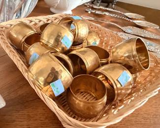 Hammered brass napkin rings and silver plate flatware
