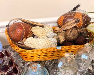 Basket of decorative gourds and pods, glass decanters