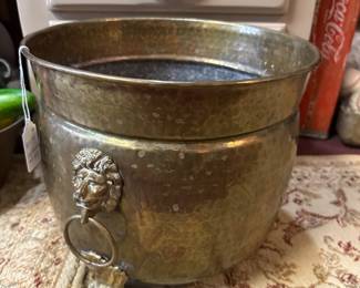 vintage hammered brass planter or jardiniere featuring decorative lion head ring handles and claw feet