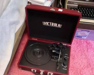 maroon Victrola Bluetooth Suitcase Turntable, a portable 3-speed record player with built-in speakers. [1] (https://www.amazon.com/Victrola-Bluetooth-Suitcase-Turntable-Speakers/dp/B00Z0IBLH8)