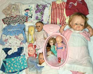 several dolls and handmade clothing