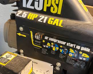 This is a Central Pneumatic 21-gallon air compressor with a 2.5 horsepowermotor. It has a maximum pressure rating of 125 PSI. The unit features dual pressure gauges for monitoring tank and outlet pressure.
