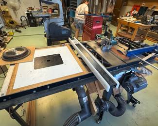  Craftsman Contractor Table Saw   220v Cast iron table with cast iron wings After market Upgrades:  Paddle stop power switch.  Incra V27 miter gauge Miter gauge fence with work stop Shop Fox Fence and 54” table extension no Built in Router Table with dust collection box and Dewalt Router installed.  Riving Knife.  Link belt.   Balanced v pulleys (available but not installed)  4” dust collection with blast gates for saw and router. Retractable Casters 