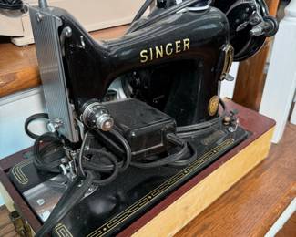 Vintage Singer 99K electric sewing machine from the 1950s, featuring a classic black enamel finish with gold decals