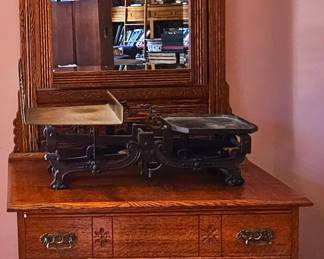 Antique oak washstand cabinet with slanting mirror.