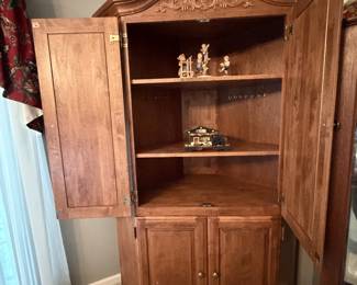 Adjustable four shelf corner cabinet.
