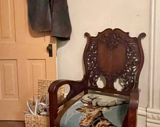 ANTIQUE SWISS 19TH CENTURY BLACK FOREST ARMCHAIR WITH CARVINGS AND NEEDLEPOINT DEER SEAT, LEATHER CHAPS