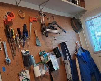 Assorted Hand Tools and Household Items on Pegboard