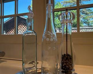 Glass cruet set with pepper mill on silver tray