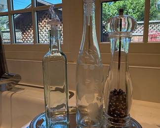 Glass cruet set with pepper mill on silver tray