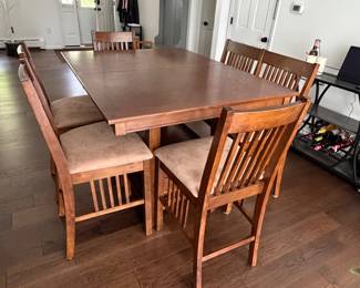 Pub style dining table with hidden leaf and seating for 6