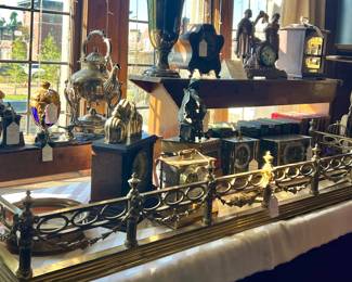 ANTIQUE BRASS FIREPLACE FENDER, ANTIQUE CLOCKS, LEATHER BOUND BOOKS AND MORE