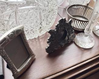 Ornate silver picture frames and cut glass bowl