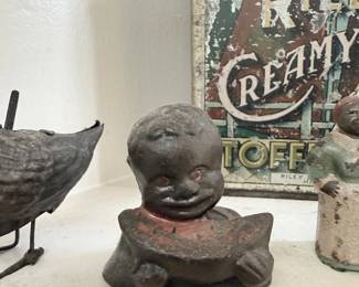 Antique cast iron figural still bank and Riley's Toffee tin