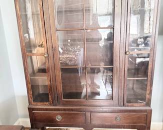 Antique mahogany glass-front china cabinet with claw feet