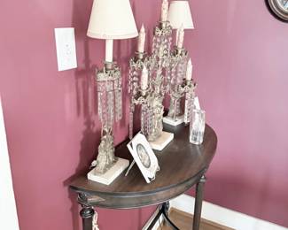 Crystal prism candle lamps on iron demilune console table